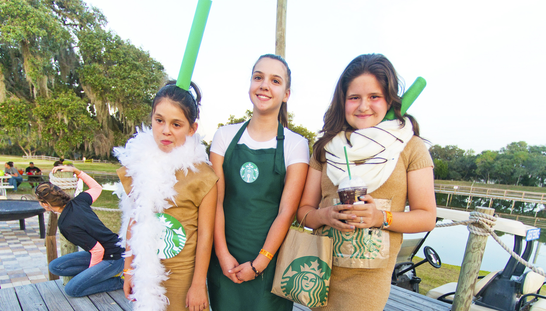 Group of girls dressed up as Starbucks coffee and baristas.