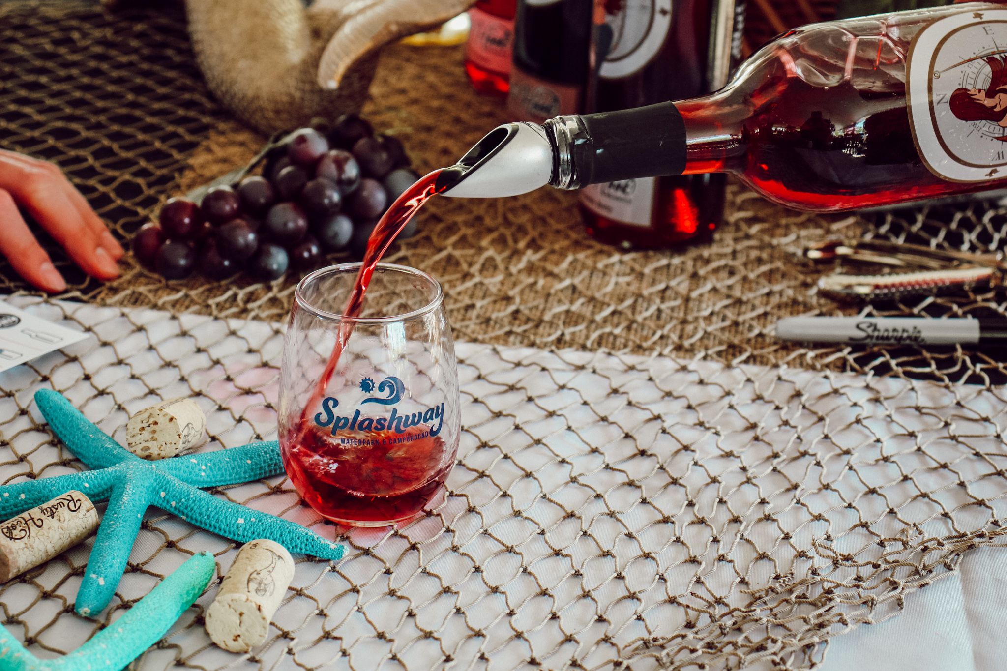Red wine being poured into a Splashway wine glass.