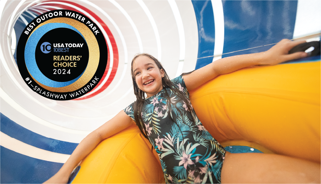A smiling girl in a floral swimsuit rides an inflatable tube down a water slide tunnel. A badge indicates "Best Outdoor Water Park" by USA Today Readers' Choice 2024, awarded to Splashway Waterpark.