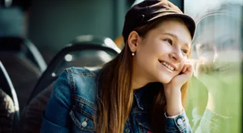 Shuttle to Splashway!<br />Two women in blue shirts and aprons smile while working inside a food truck.<br />